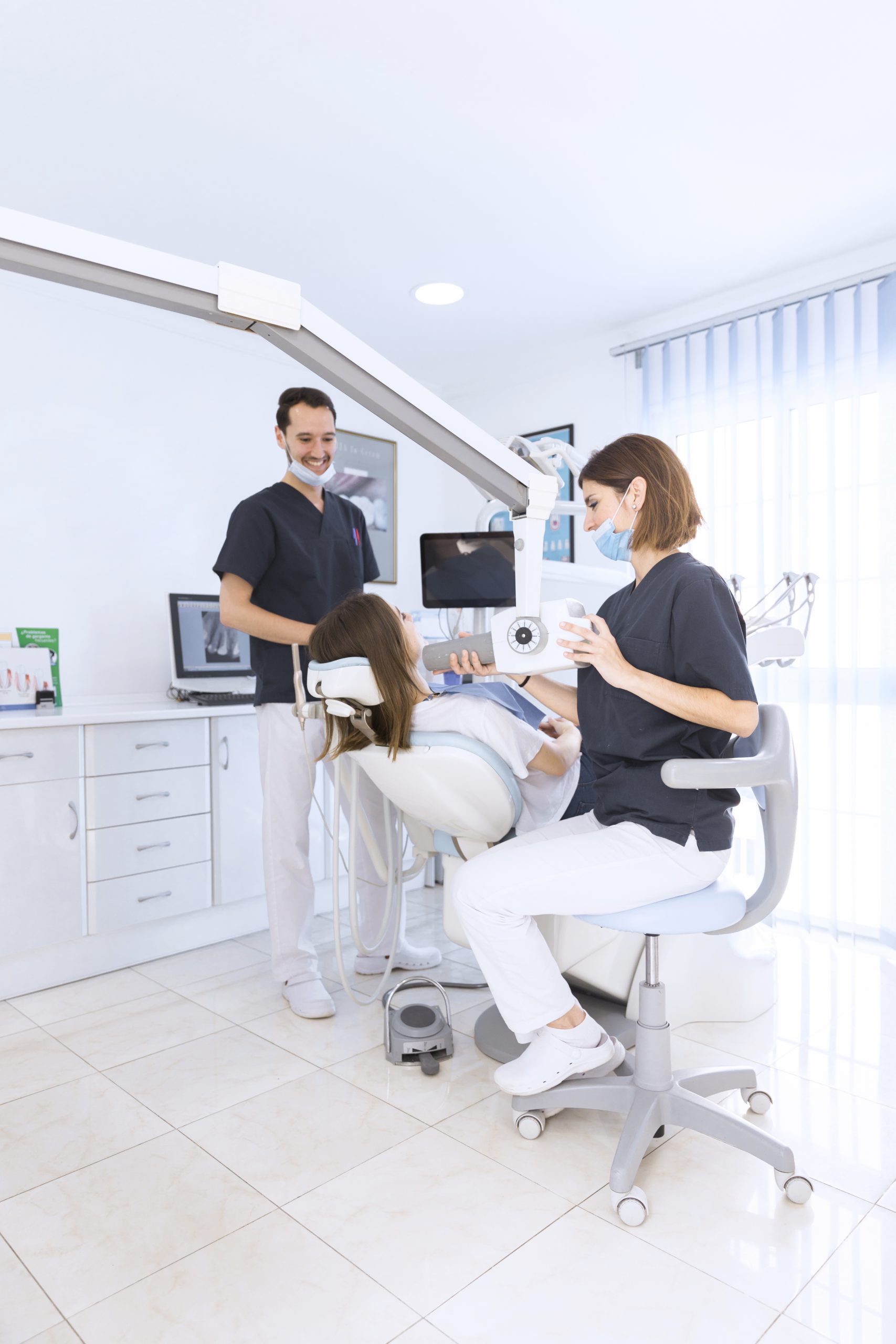 female-dentist-scanning-patient-s-teeth-with-x-ray-machine-modern-dental-clinic